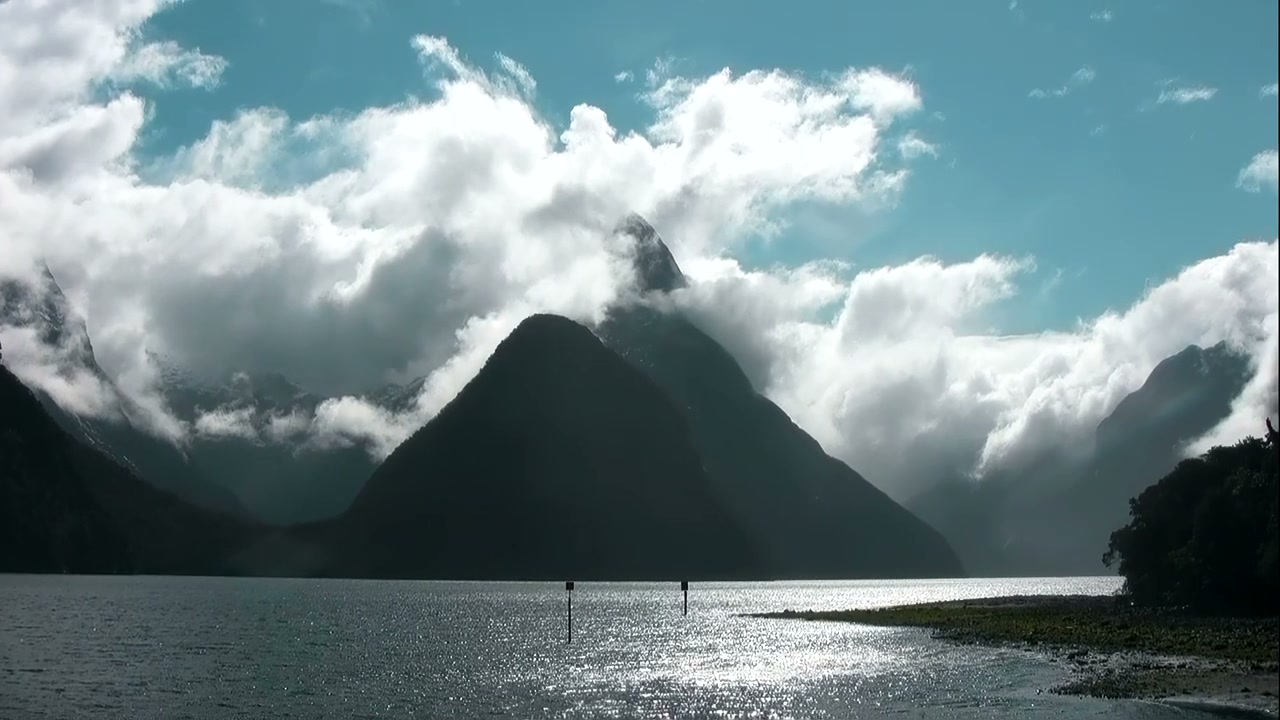 Mountains rising from a still fjord, New Zealand
